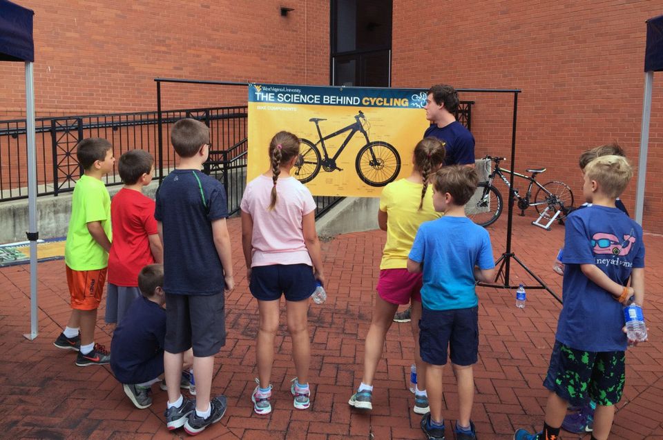 A group of students learning about bike components. 